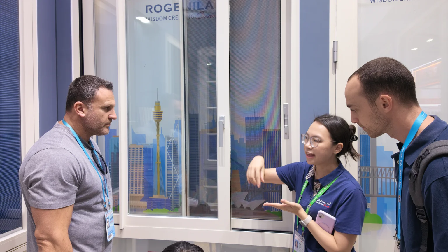 Window Discussion at the April 2026 Canton Fair Rogenilan team discussing a window display with visitors in April 2026